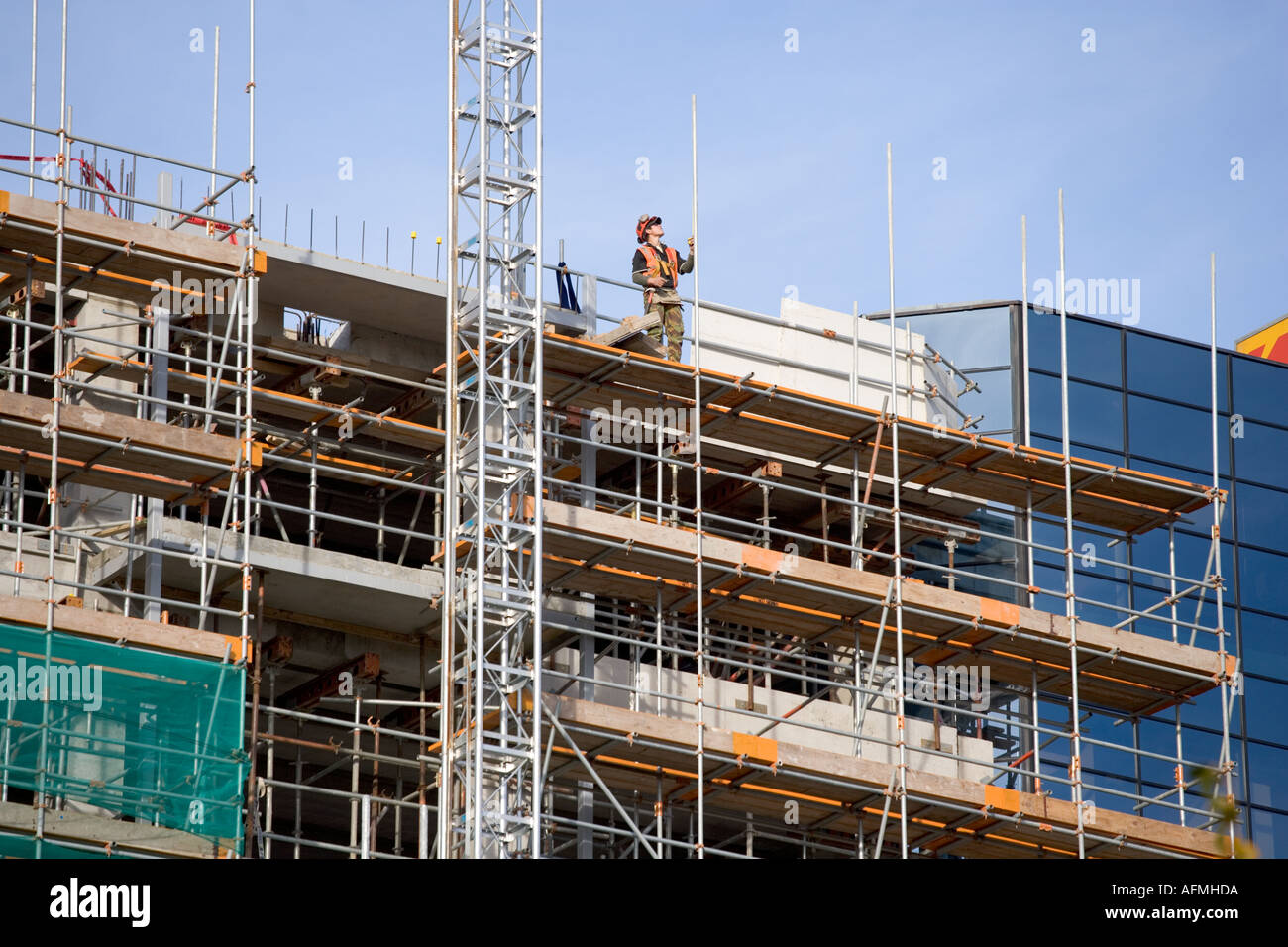 A construction worker high up on a building site Stock Photo - Alamy