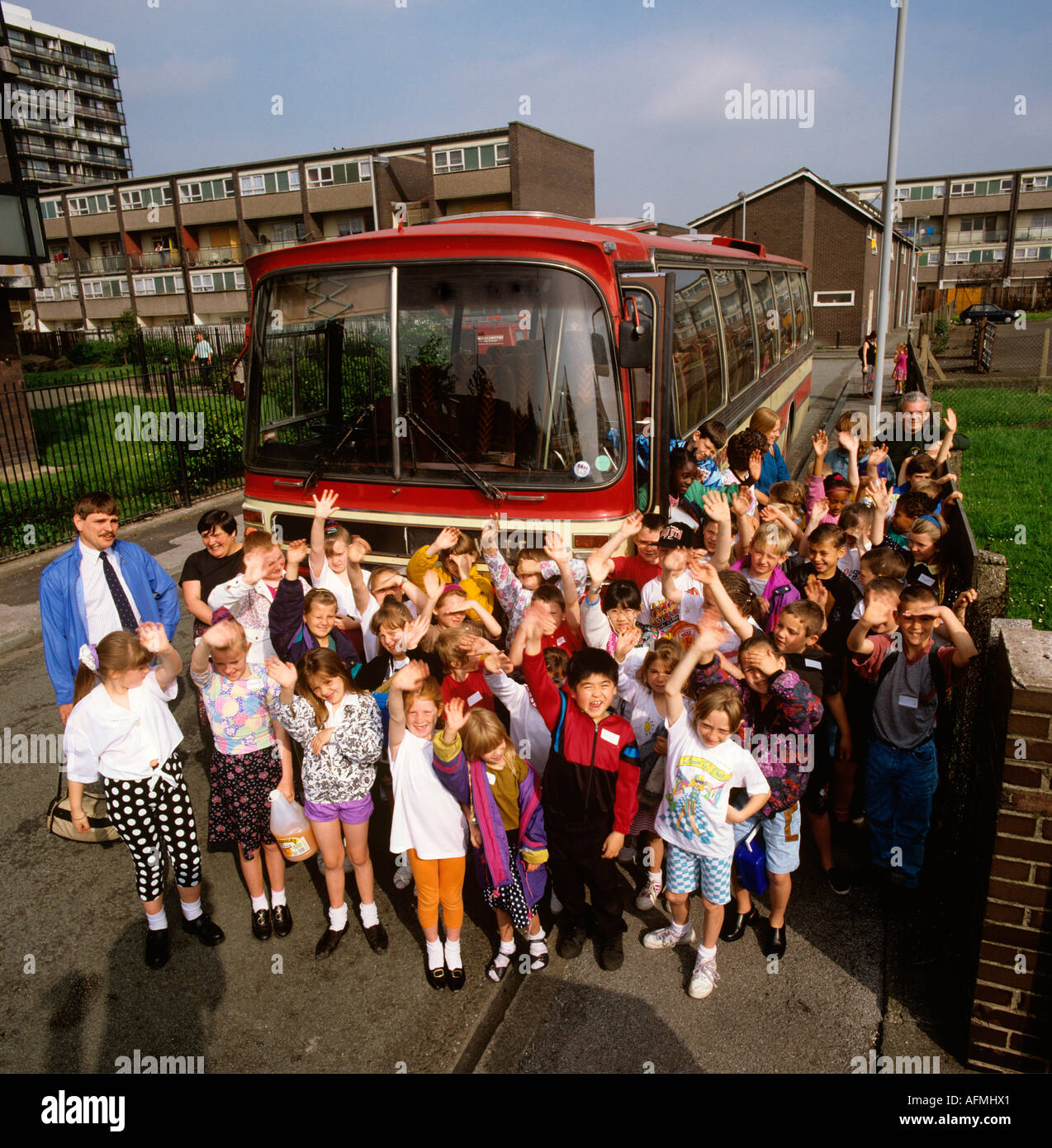 Education group of children leaving school on coach trip Stock Photo