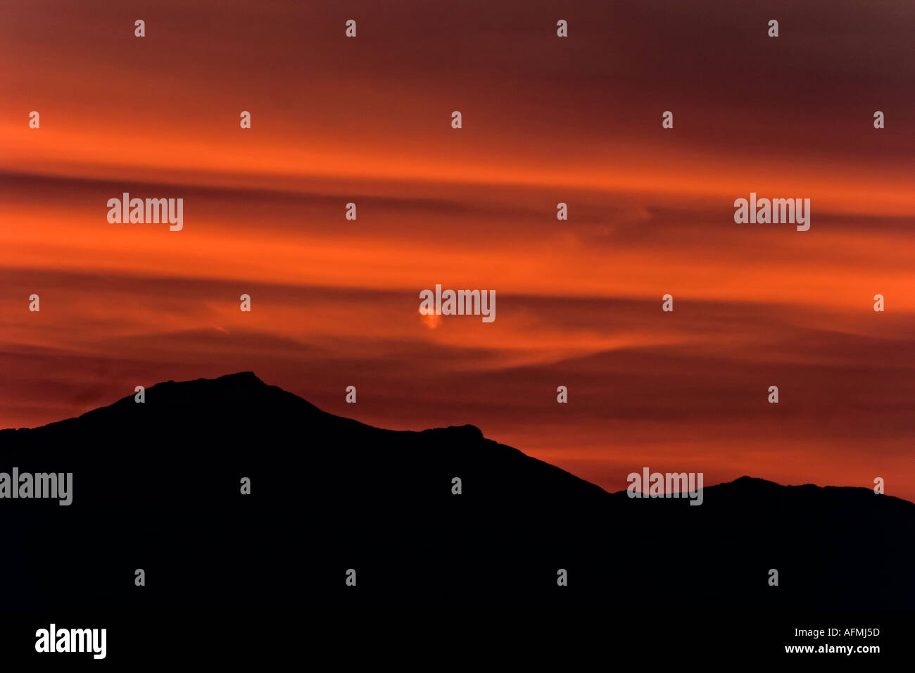 sunset on mountains with smooth red sky Stock Photo