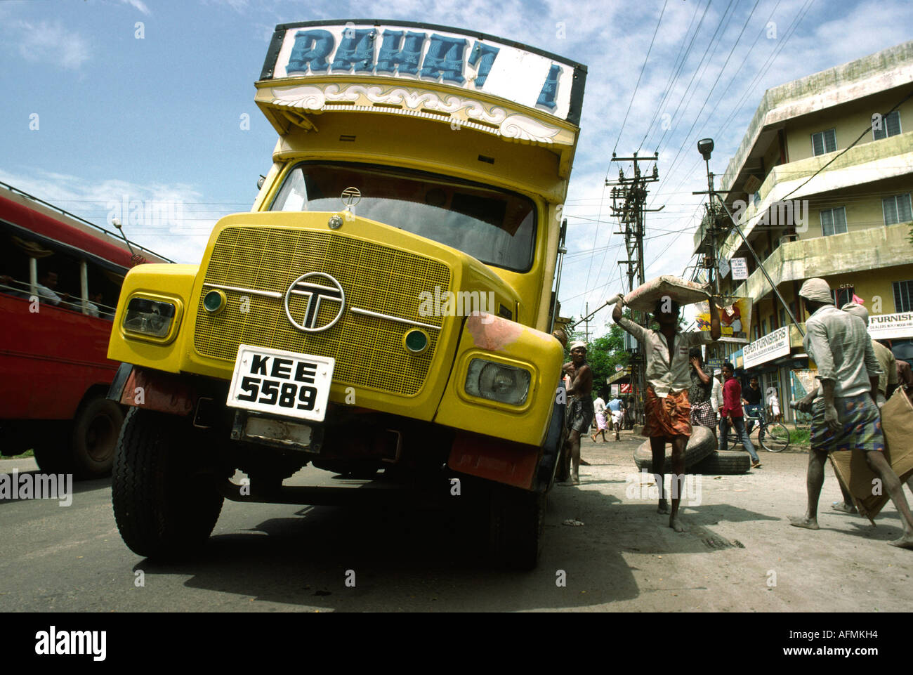 India Kerala Cochin transport unloading truck with broken axle Stock Photo