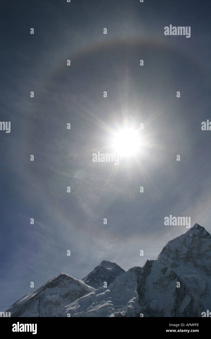 Solar halo over Mount Everest AKA Chomolungma Thin high altitude clouds known as cirrostratus fibratus clouds cause this halo Stock Photo