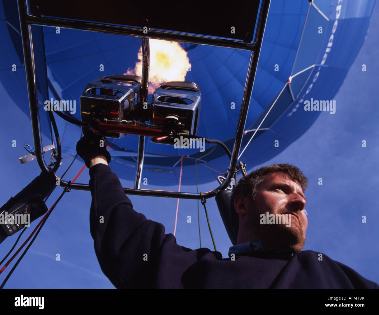 Hot air balloon pilot fires the burner igniting a jet of propane gas