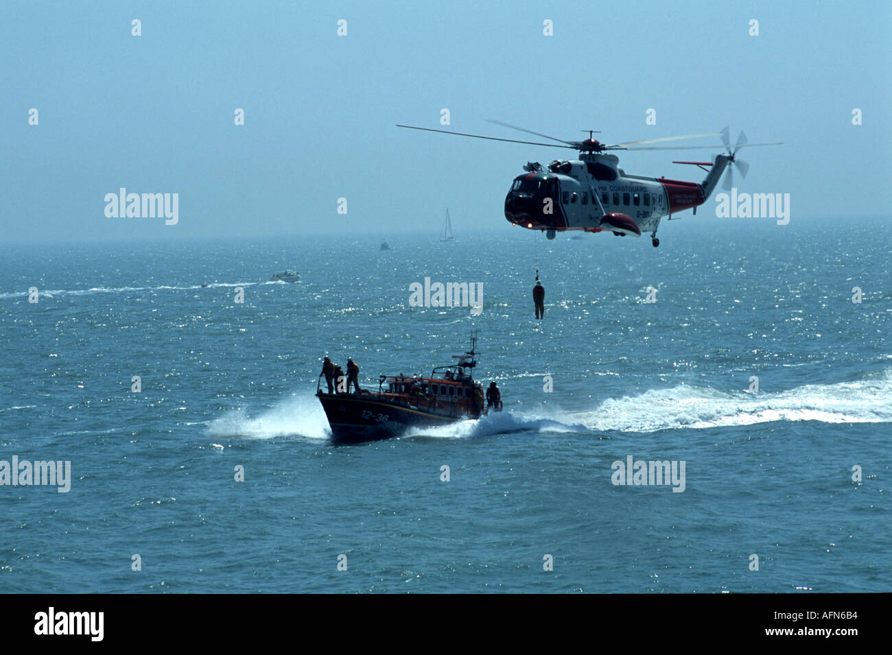 Search and rescue helicopter with man on winch Stock Photo - Alamy
