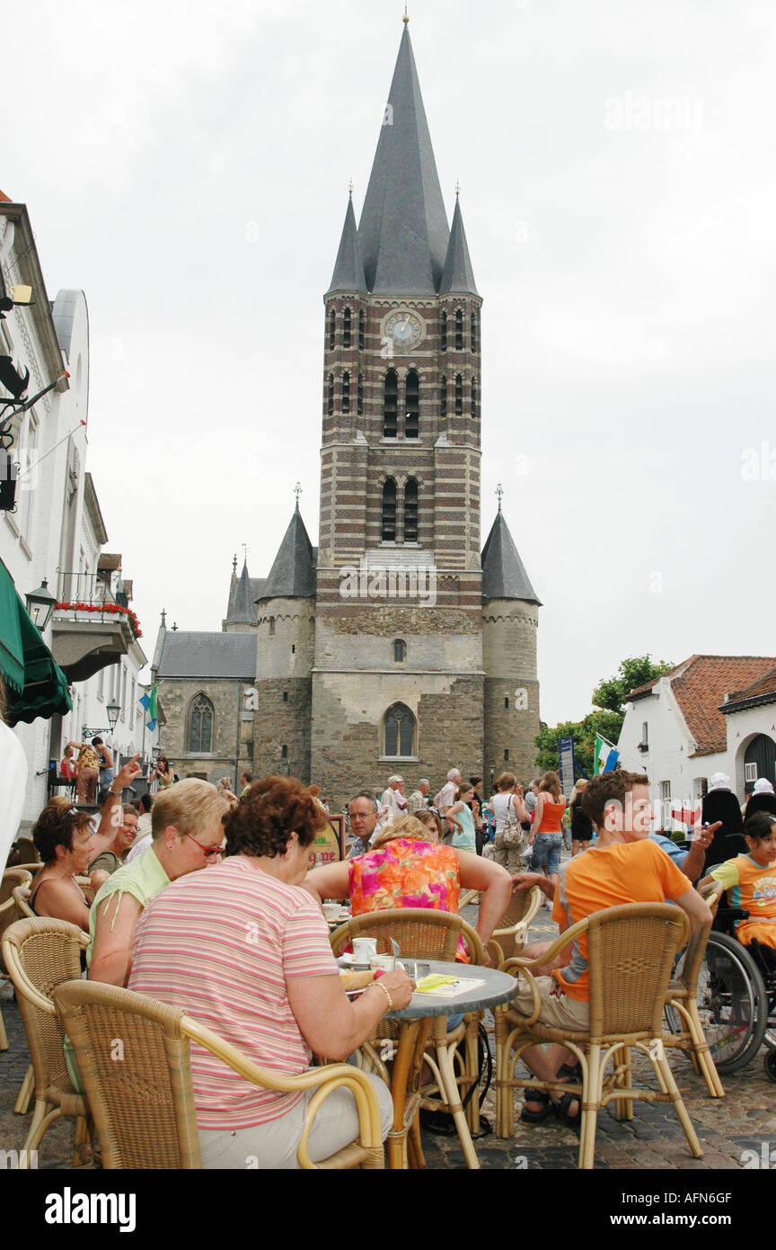 Wijngaard square with gothic church and tourists having a drink at terrace of roadside cafe Thorn Limburg Netherlands Stock Photo