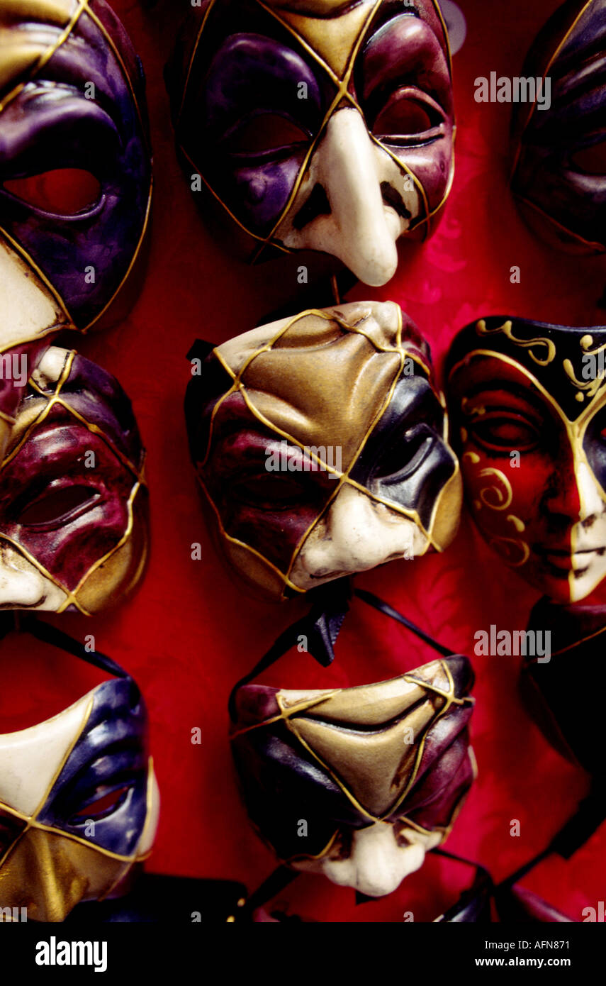 Many souvenir face masks hung on a wall in a tourist souvenirs shop in