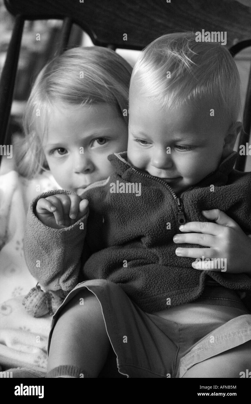 Little Girl Looking After Her Baby Brother Stock Photo