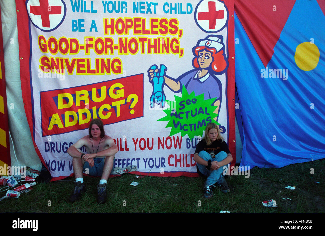 Generation X concert goers sit under a sarcastic banner during