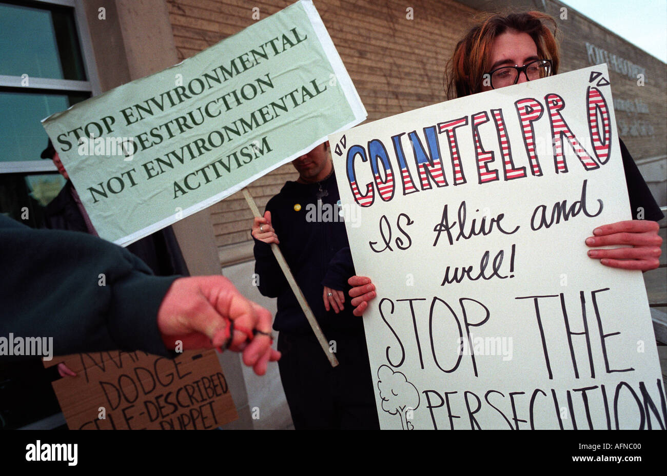 Protesters hold signs protesting FBI surveillance on American activists involved in activities of Earth First! and other groups. Stock Photo