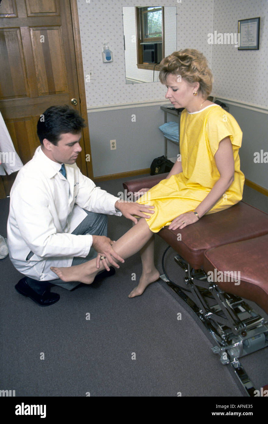 Chiropractor works with and makes adjustment to female Stock Photo