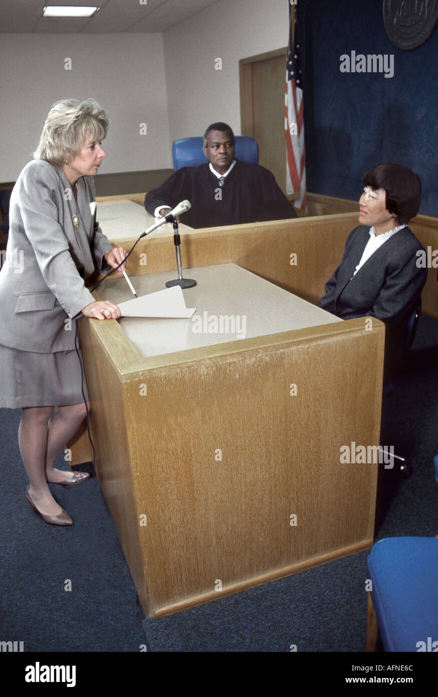 Female lawyer prosecutor questions Asian witness with black judge