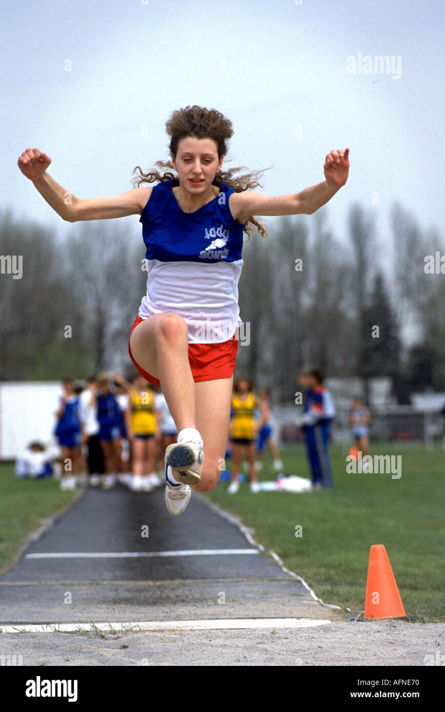 High school female participate in track and field long jump Stock Photo