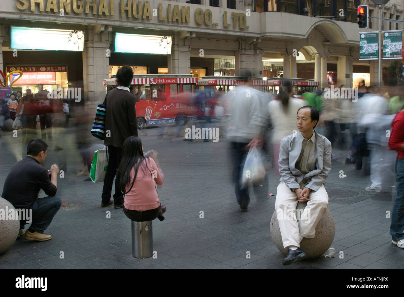 Shoppers on bollards Stock Photo