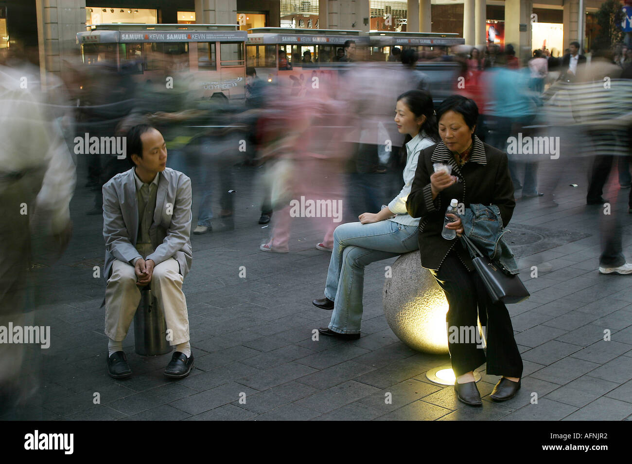 Shoppers on bollards Stock Photo
