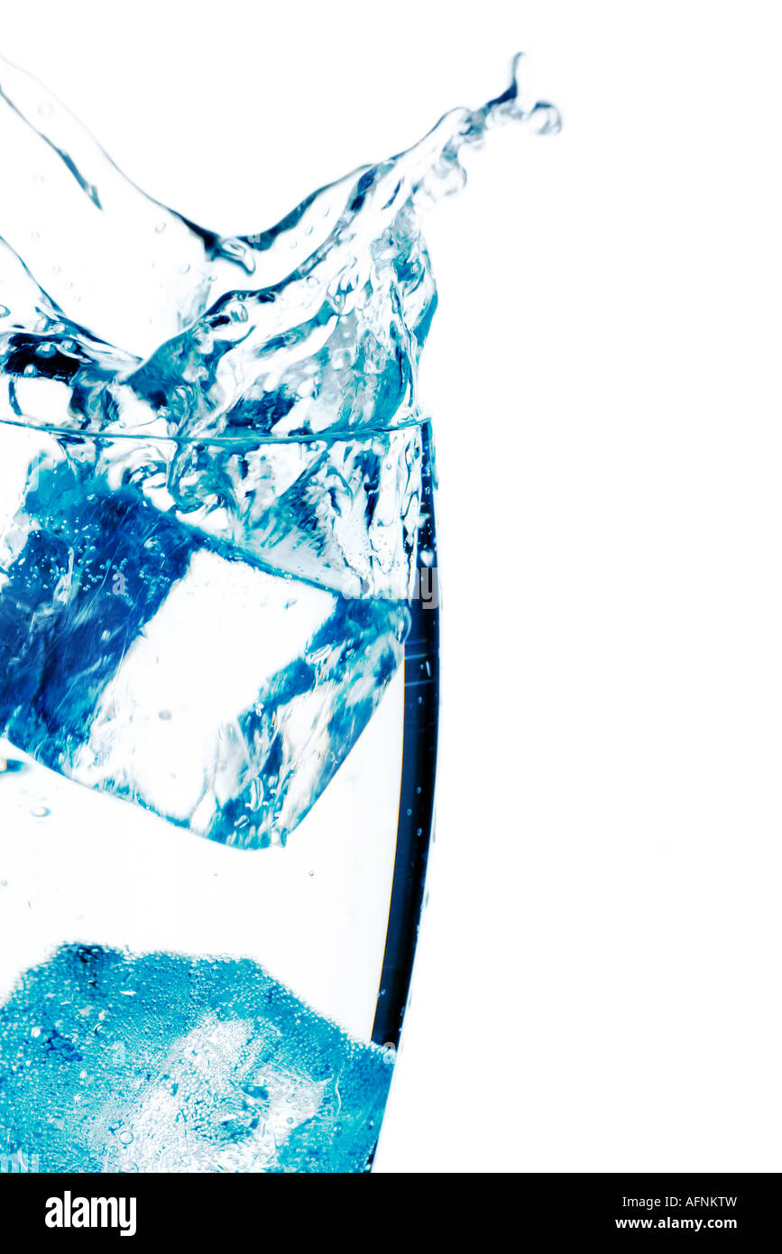 ice cubes falling into a cool glass of water Stock Photo - Alamy