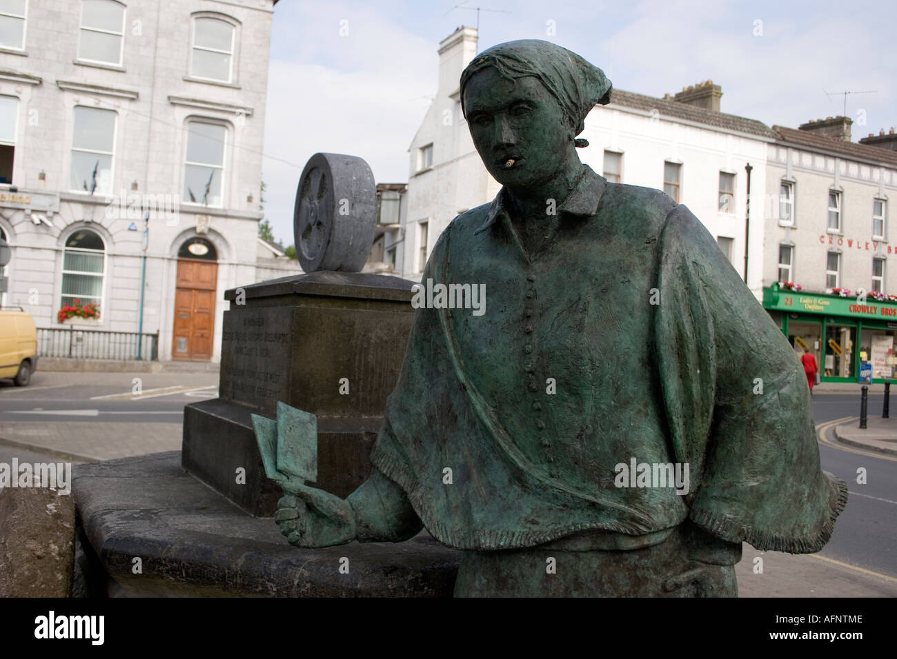 defaced bronze Statue of female Irish farm worker with cigarette in mouth Stock Photo