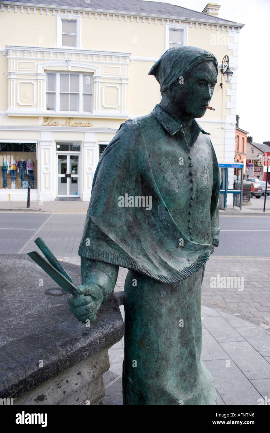 defaced bronze Statue of female Irish farm worker with cigarette in mouth Stock Photo