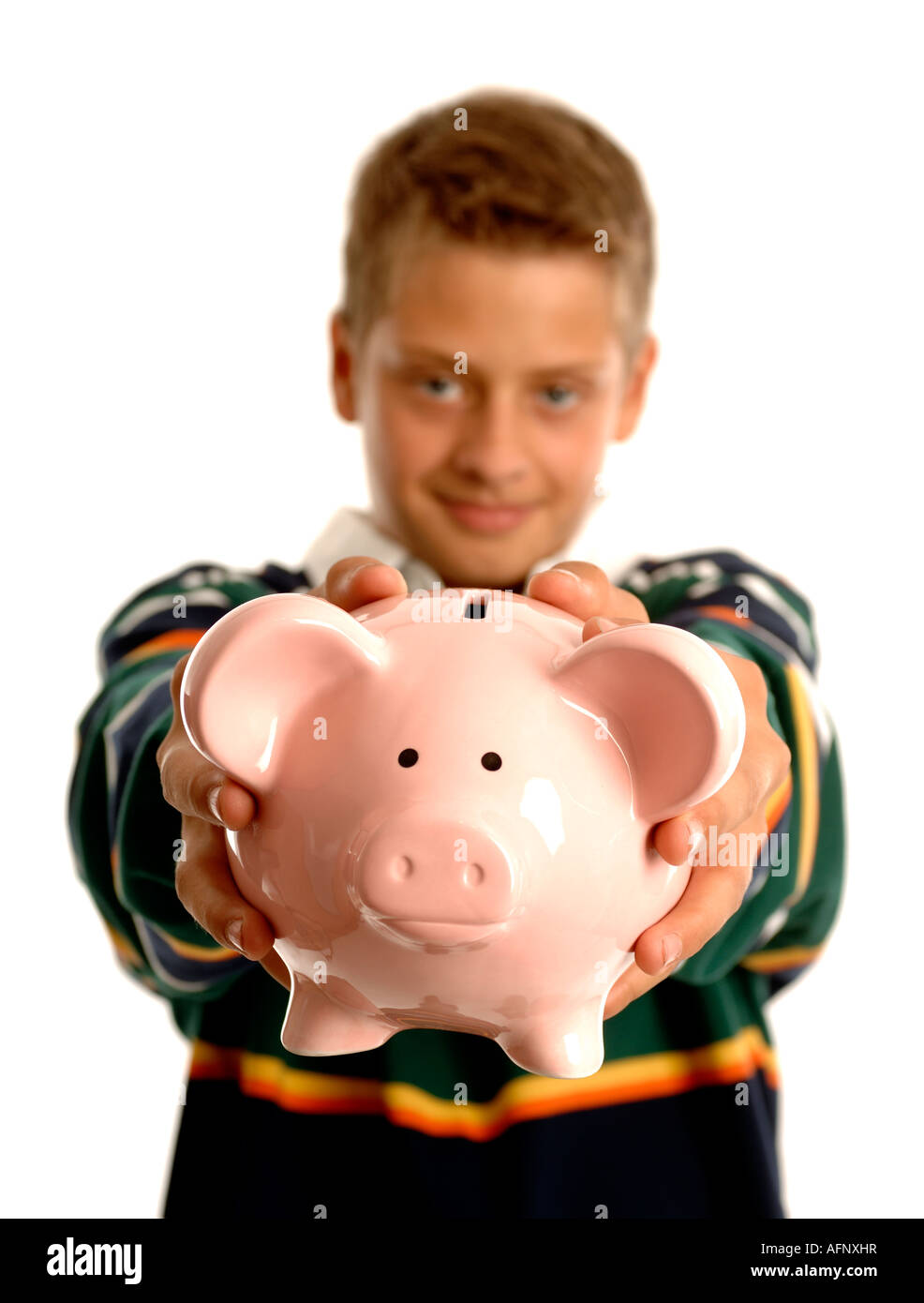 Boy with arms outstretched holding a piggy bank Stock Photo