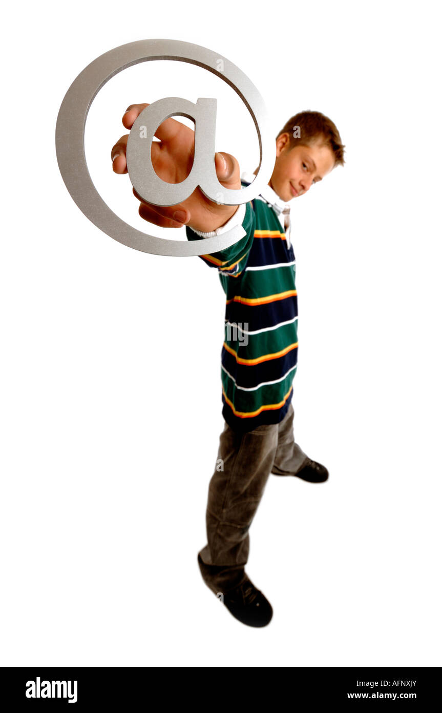 Boy with arm outstretched holding an email at symbol Stock Photo