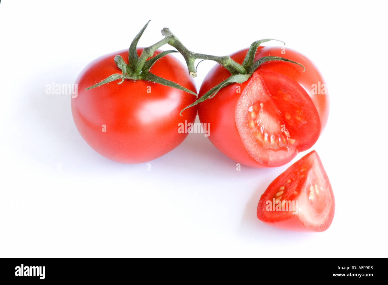 Vine ripened tomato against a white background Stock Photo - Alamy