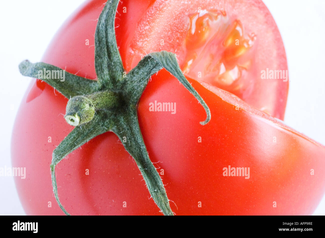 Vine ripened tomato against a white background Stock Photo