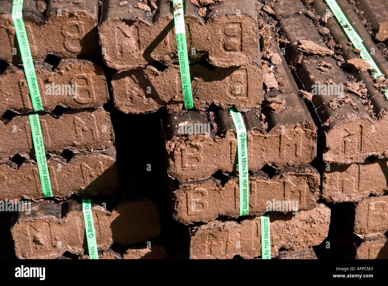 A stack of peat blocks ready for the fire in Broughshane County Antrim  Northern Ireland Stock Photo