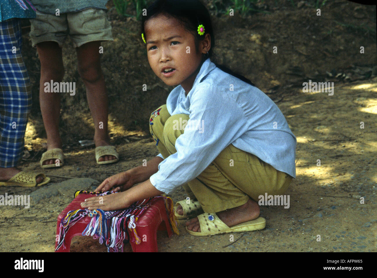 Girl selling locally made friendship bracelets in Mai Chau in Northern  Vietnam Stock Photo - Alamy