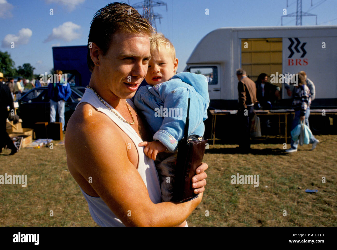 1990s UK Essex man and son carrying old style Brick mobile phone. Wearing a vest gold chain. 1991 HOMER SYKES Stock Photo
