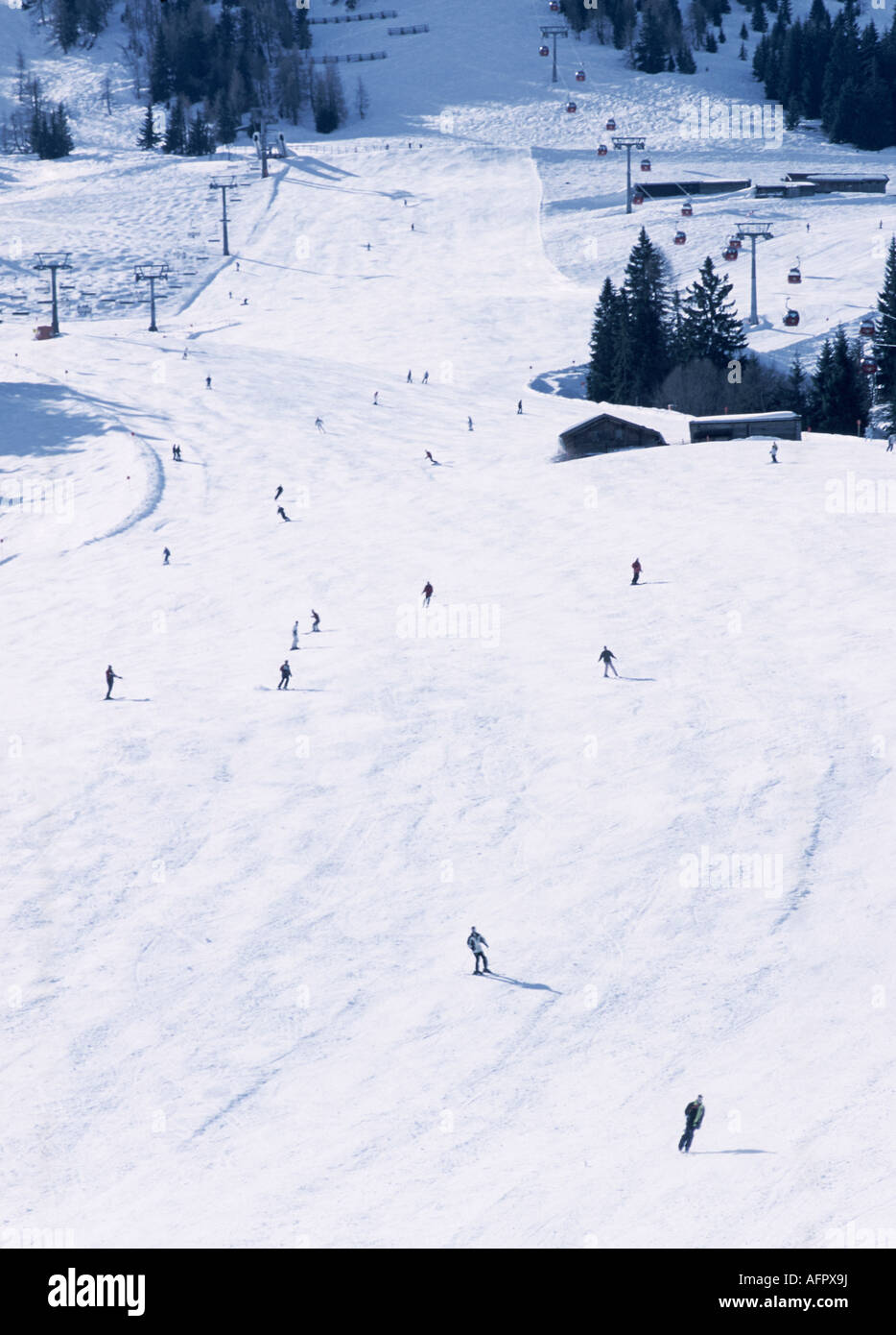 Skiers On Alpine Ski Slope at Soll Austria with Trees and Lifts Visible in Background Stock Photo