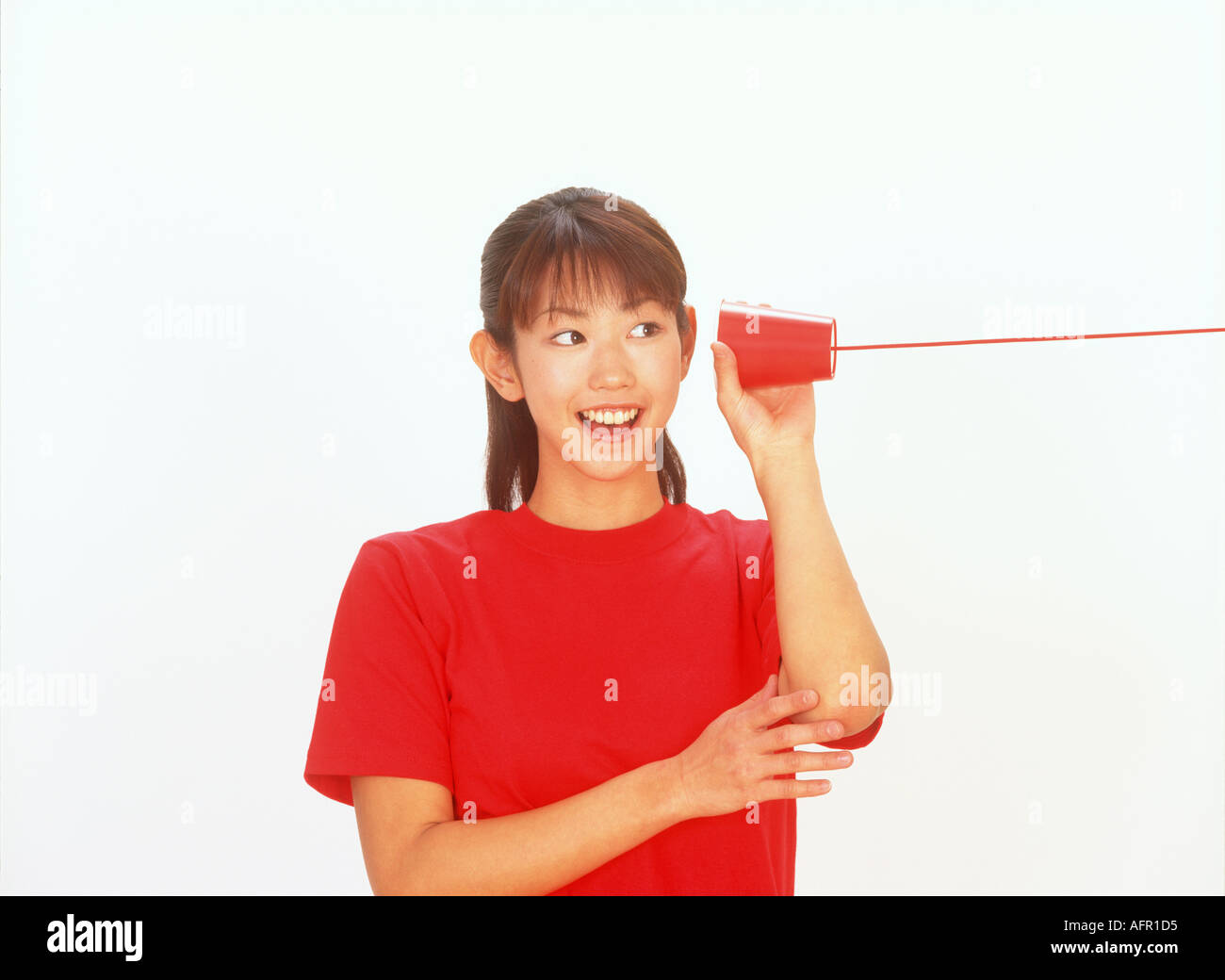 Japanese Woman Listening on String Telephone Stock Photo - Alamy