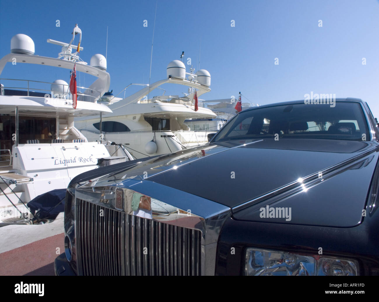 Sports cars parked next to yachts in the Luxury marina of Puerto banus,  Marbella, Spain Stock Photo - Alamy