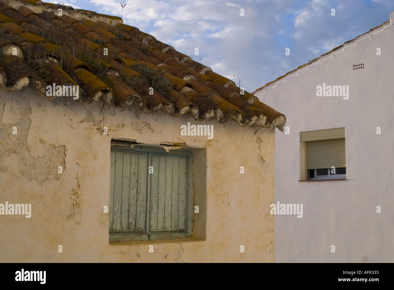 The contrast between old original wall and window and the modern version in the white village of Casares in Andalucia Spain Stock Photo