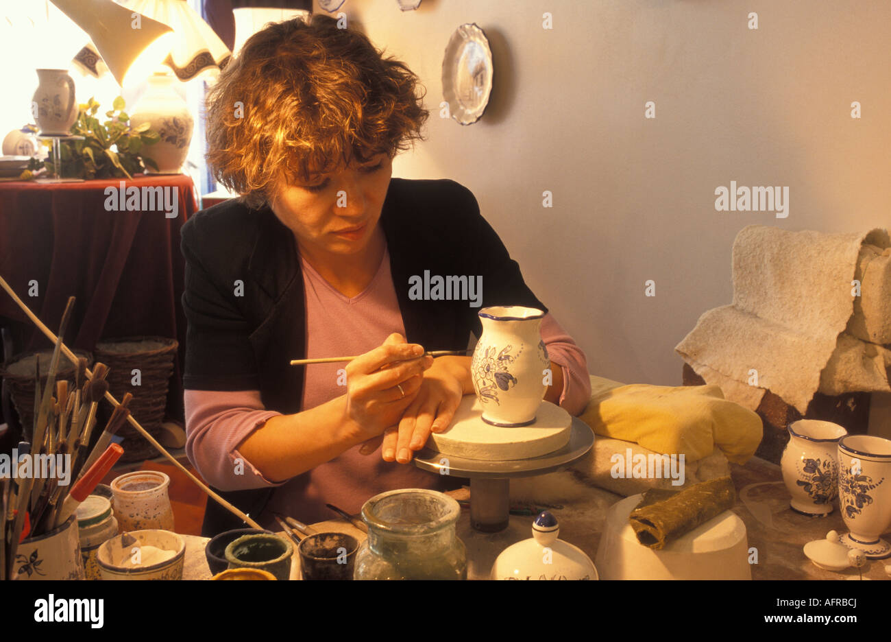 Woman producing faience at the shop Fayence Bleu in Nevers Burgundy France Stock Photo