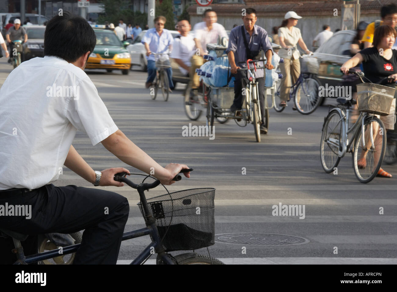 Cyclist waiting at crossing, Beijing, China. Stock Photo