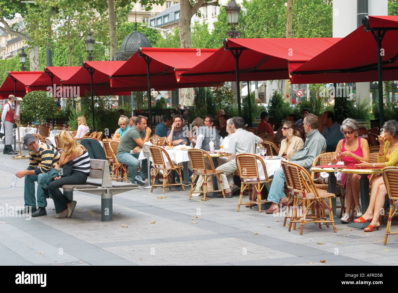 People sitting at traditional French café, on the pavement , during