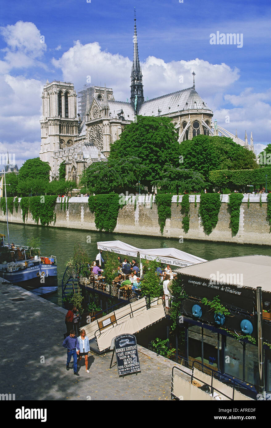 Restaurant boats on River Seine with Notre Dame Stock Photo