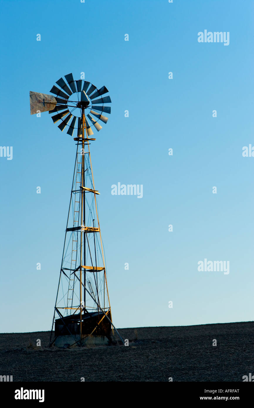Agricultural windmill in fallow wheat field. Stock Photo