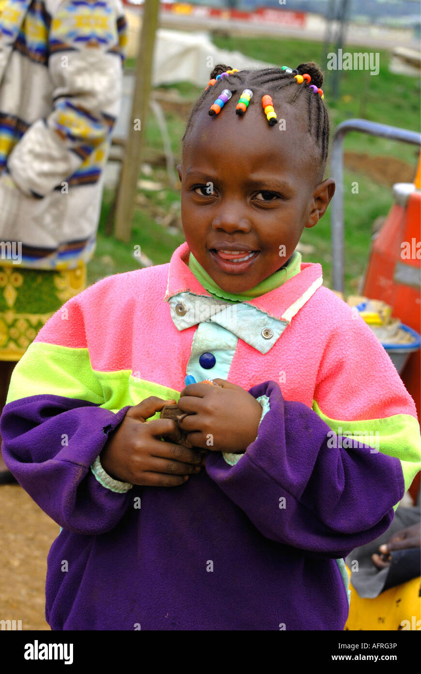 A pretty young Kikuyu girl in modern dress with coloured plastic beads in her hair Kenya East Africa Stock Photo