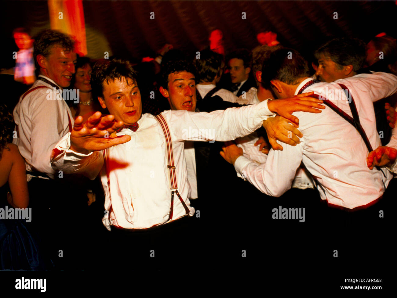 Student revellers 1990s UK. Drunk students dancing with each other Cirencester Royal Agricultural College end of year Mat Ball 1995 HOMER SYKES Stock Photo