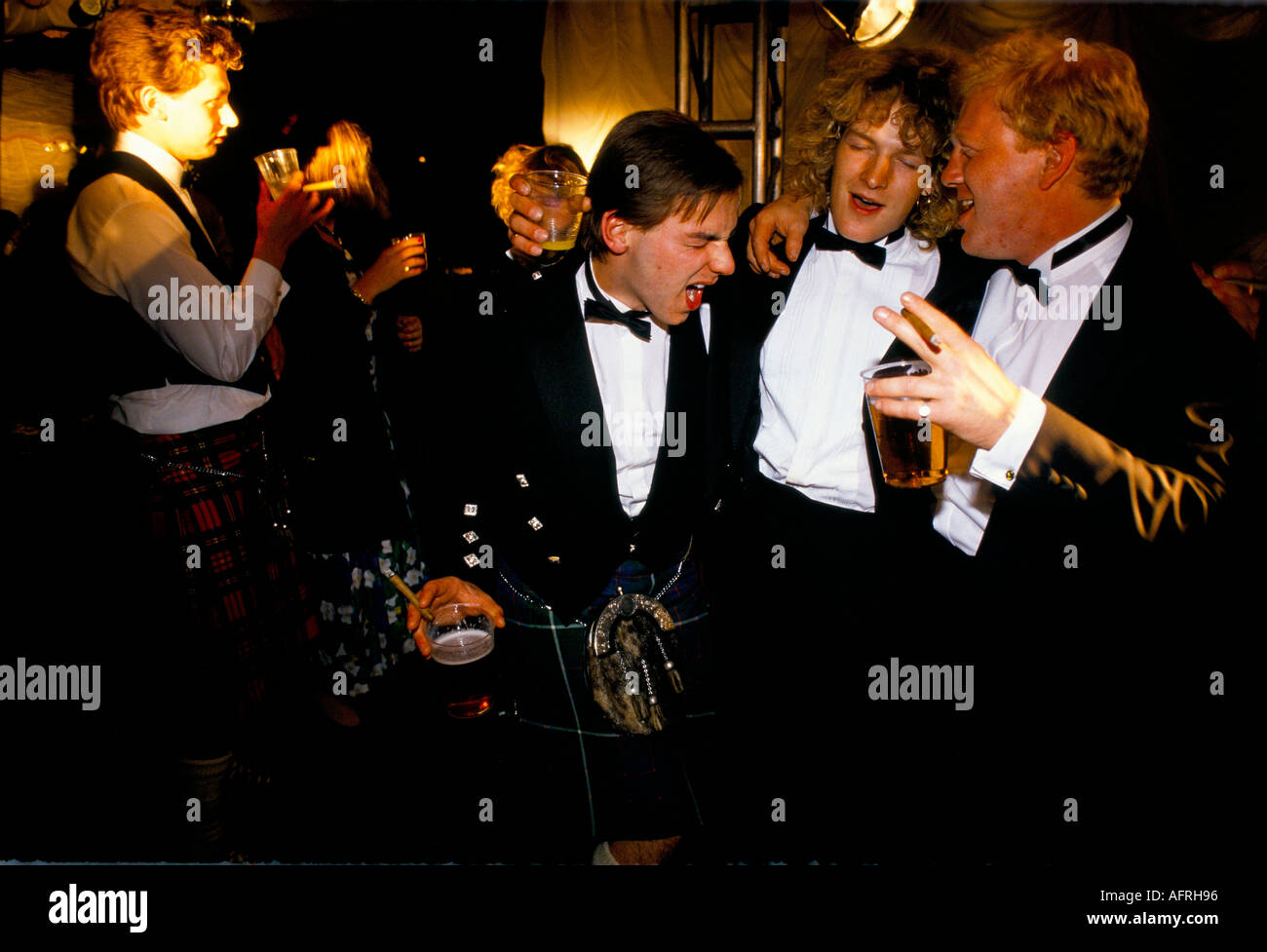 Drunk men students 1990s smoking, drinking, bonding.at annual end of year May Ball, Royal Agricultural College Cirencester UK 1995 HOMER SYKES Stock Photo