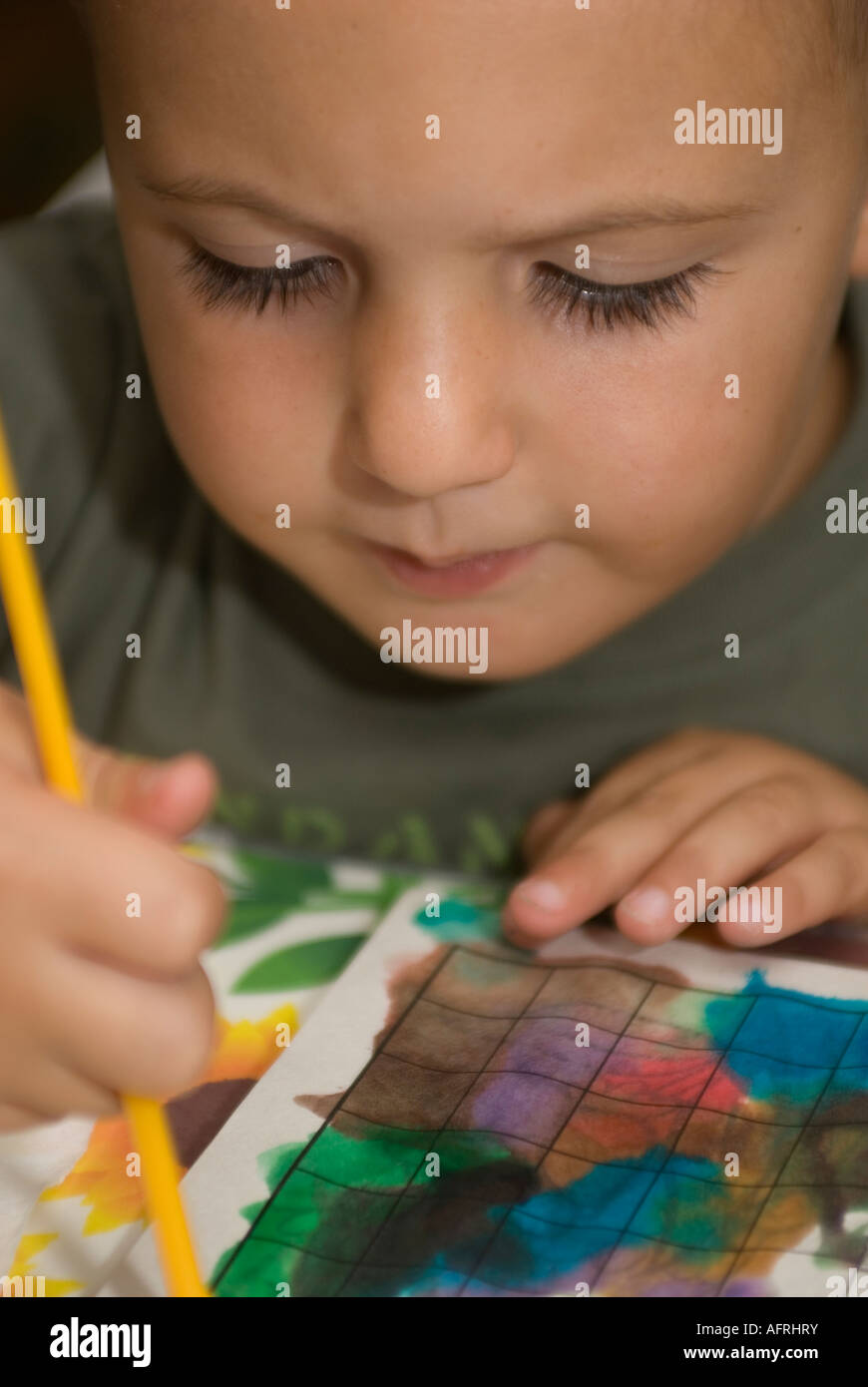 Young child learning to paint with watercolors Stock Photo Alamy
