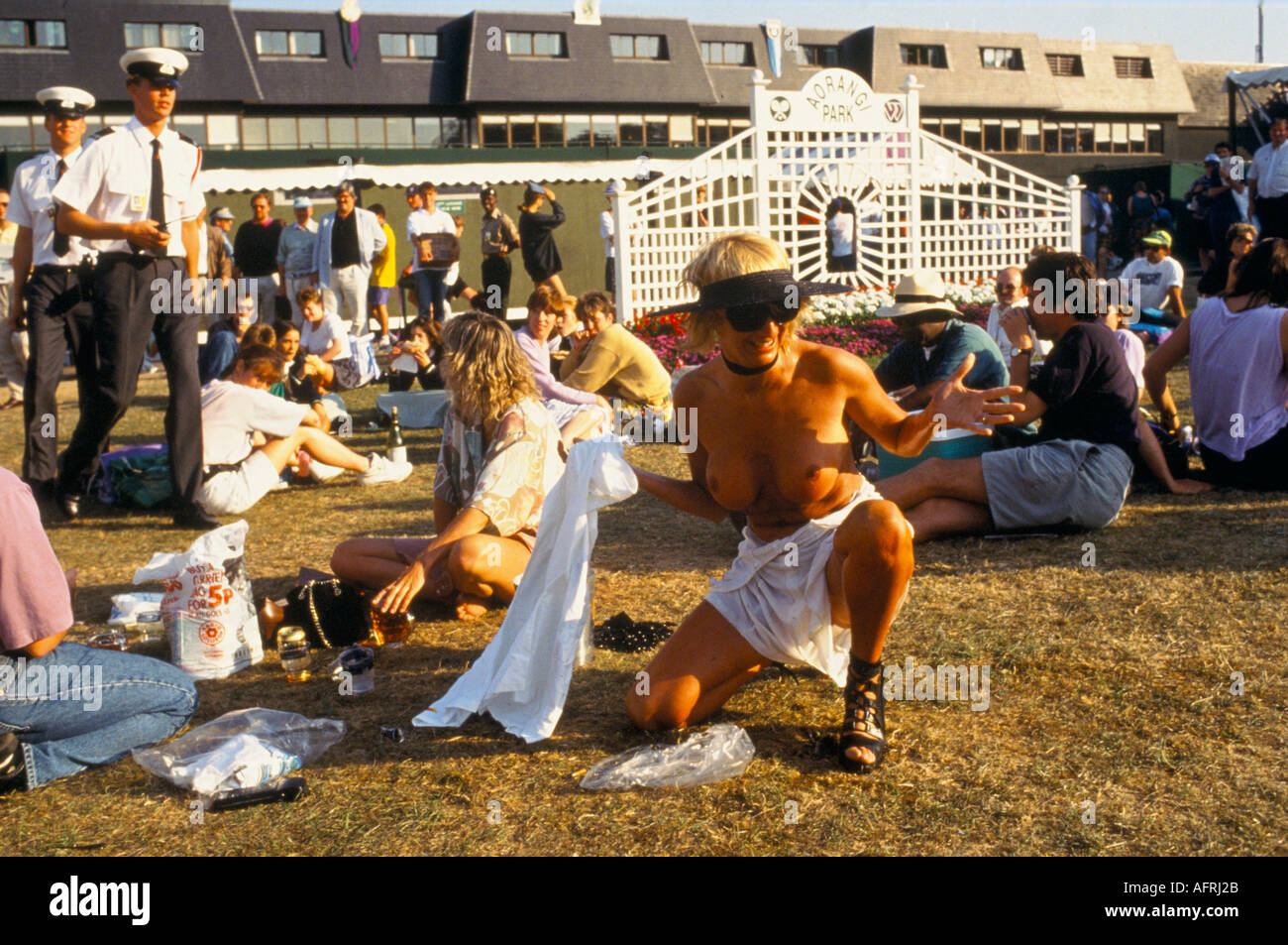 nude drunk Naked nude topless woman drunk in public bad behaviour at sporting event.  Wimbledon tennis championships Security arriving. UK 1990s 1993 HOMER SYKES  Stock Photo - Alamy