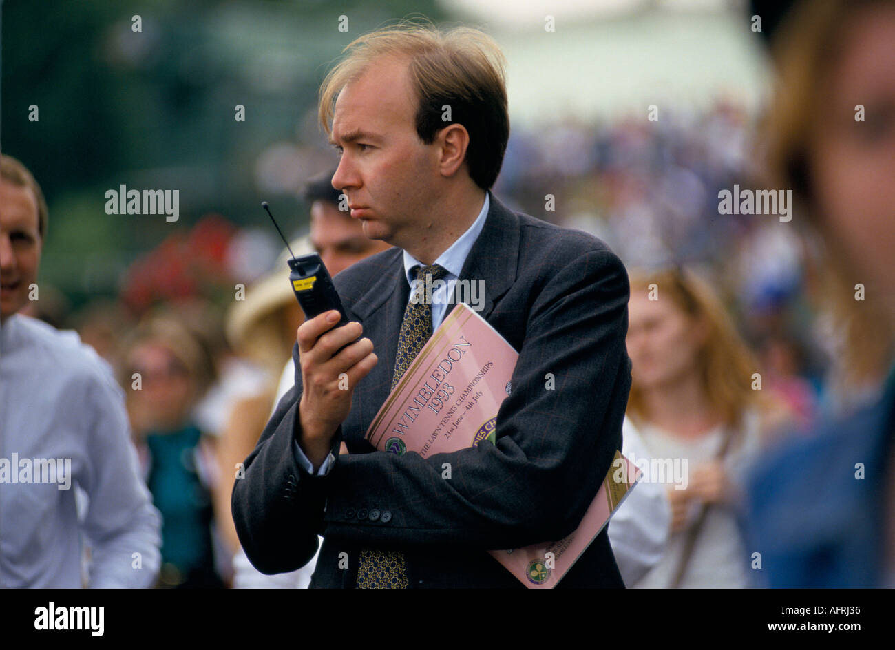Man holding old style mobile cell phone phones 1990s at Wimbledon Lawn Tennis Club during the championships 1993 UK HOMER SYKES Stock Photo
