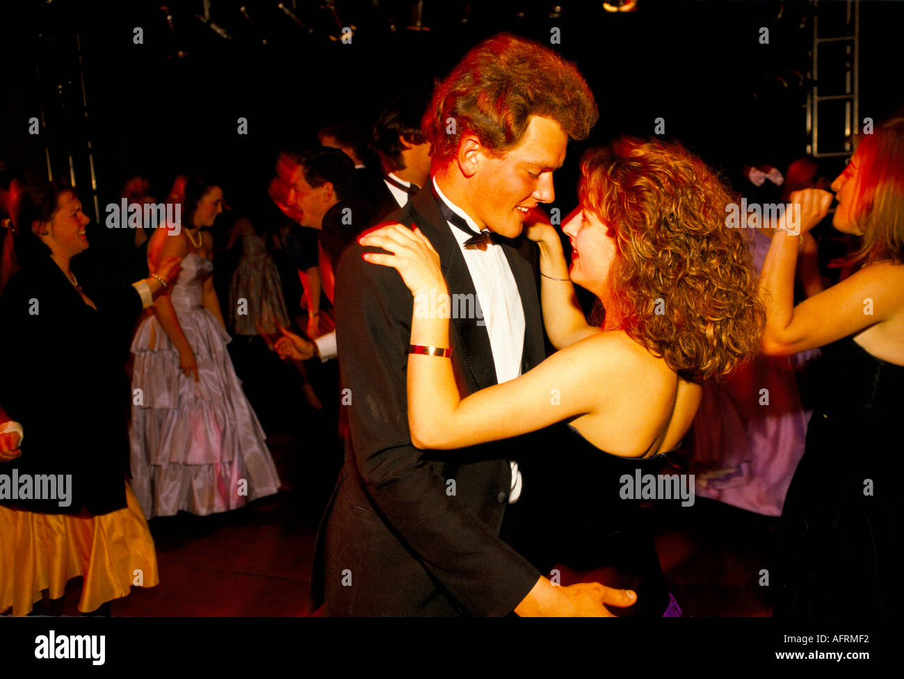 Young couple 1990s UK, in formal black tie,  ball gown dance the night away at the Cirencester Royal Agricultural College end of year summer May Ball Stock Photo