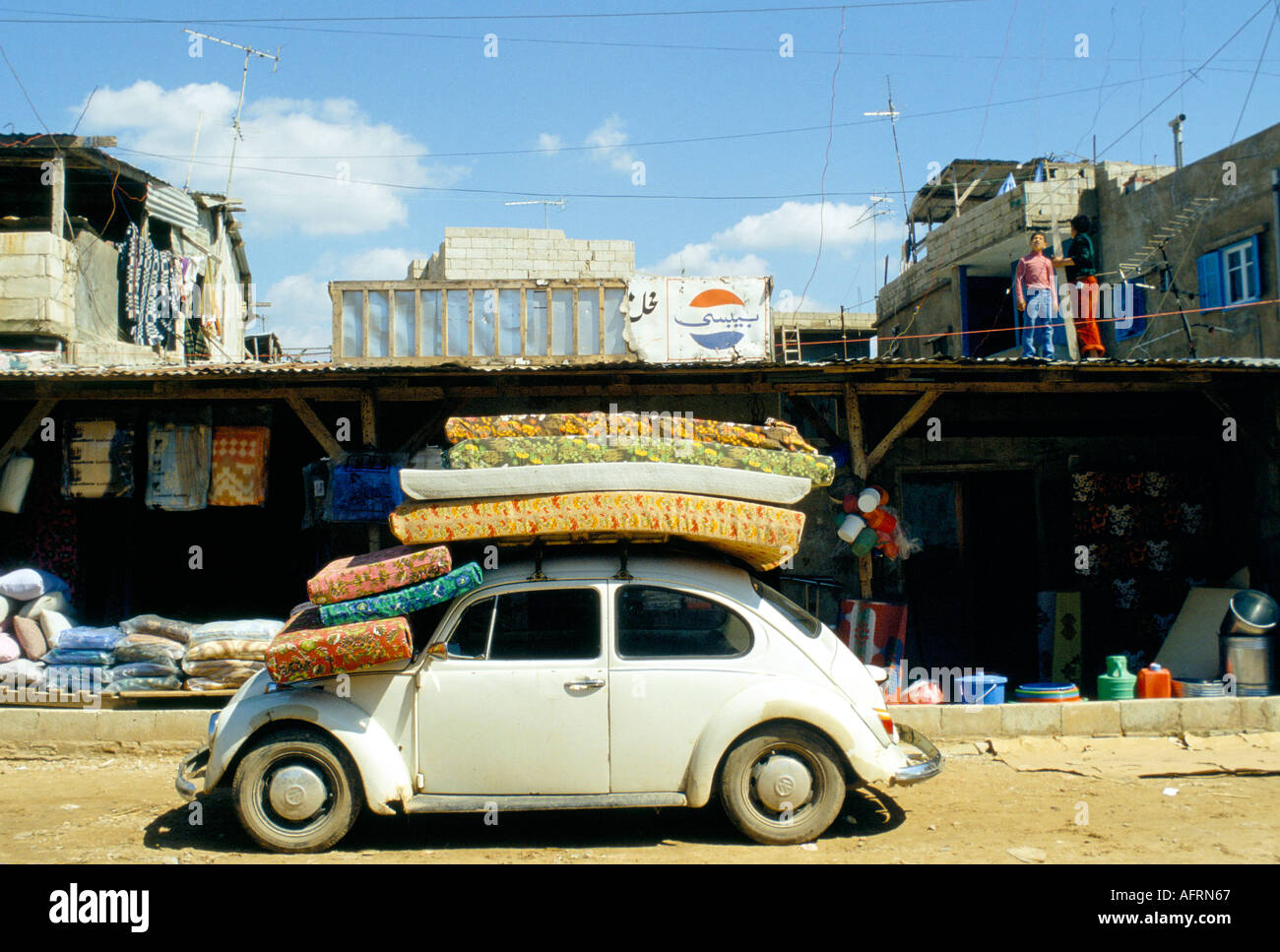 PLO Shatila Chatila Refugee Camp Beirut created for Palestine refugees 1980s a mattress shop daily life children playing on roof of build 1980 Lebanon Stock Photo