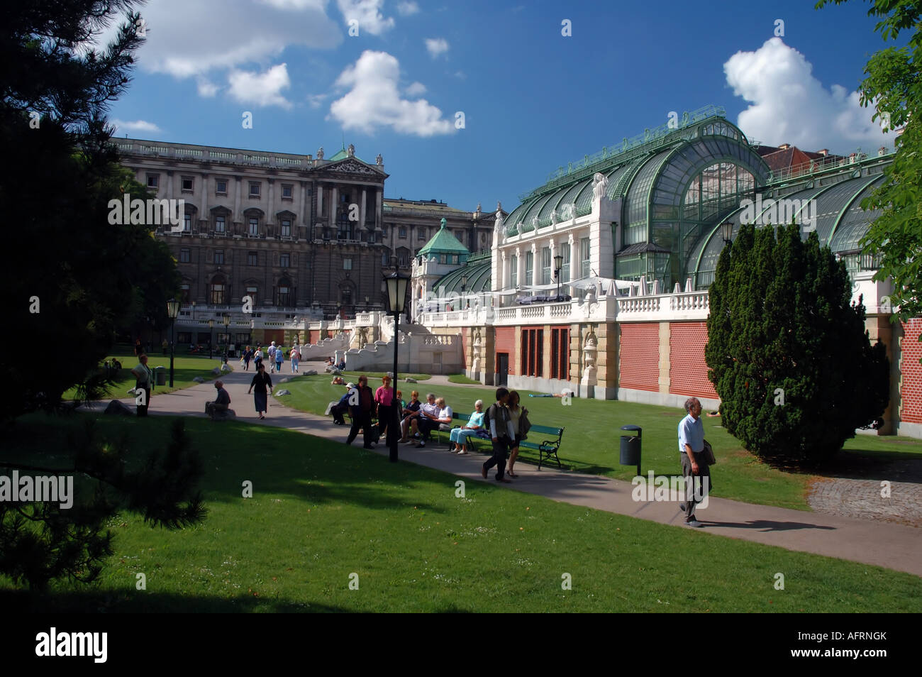 People enjoying a bright summer's day in the Hofburg Gardens near the Schmetterlinge Haus Vienna Austria No MR or PR Stock Photo