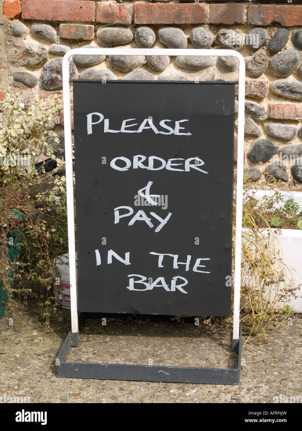 Blackboard sign saying Please order and pay in the bar Stock Photo
