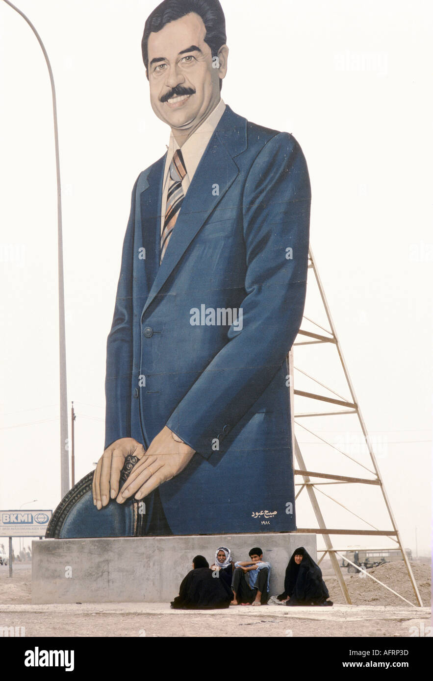 Saddam Hussein portrait  in business suit on the road side route from  Baghdad to Basra. Iraq HOMER SYKES Stock Photo