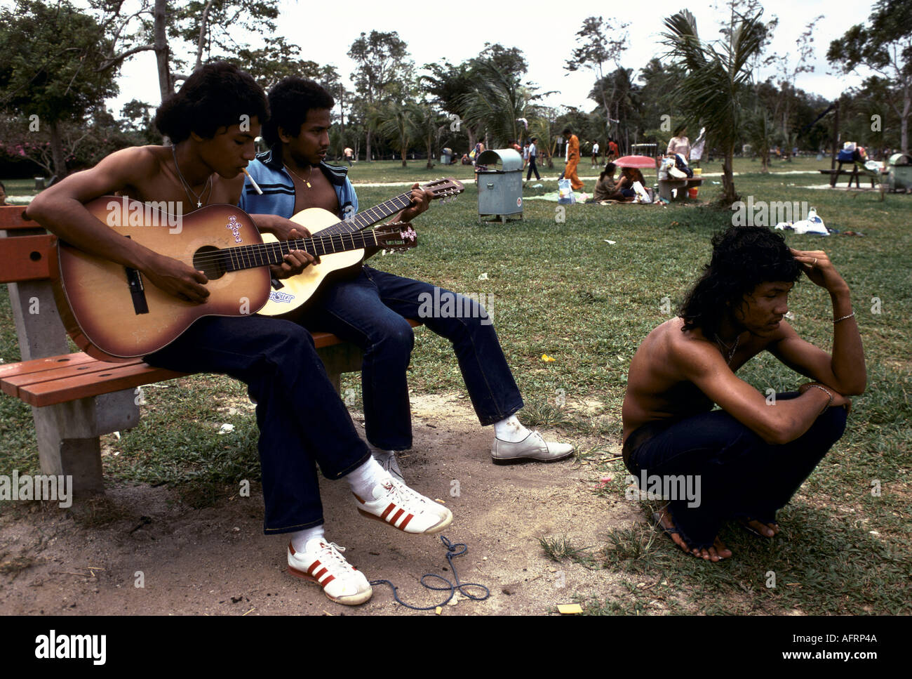 playING GUITAR IN THE PARK Stock Photo
