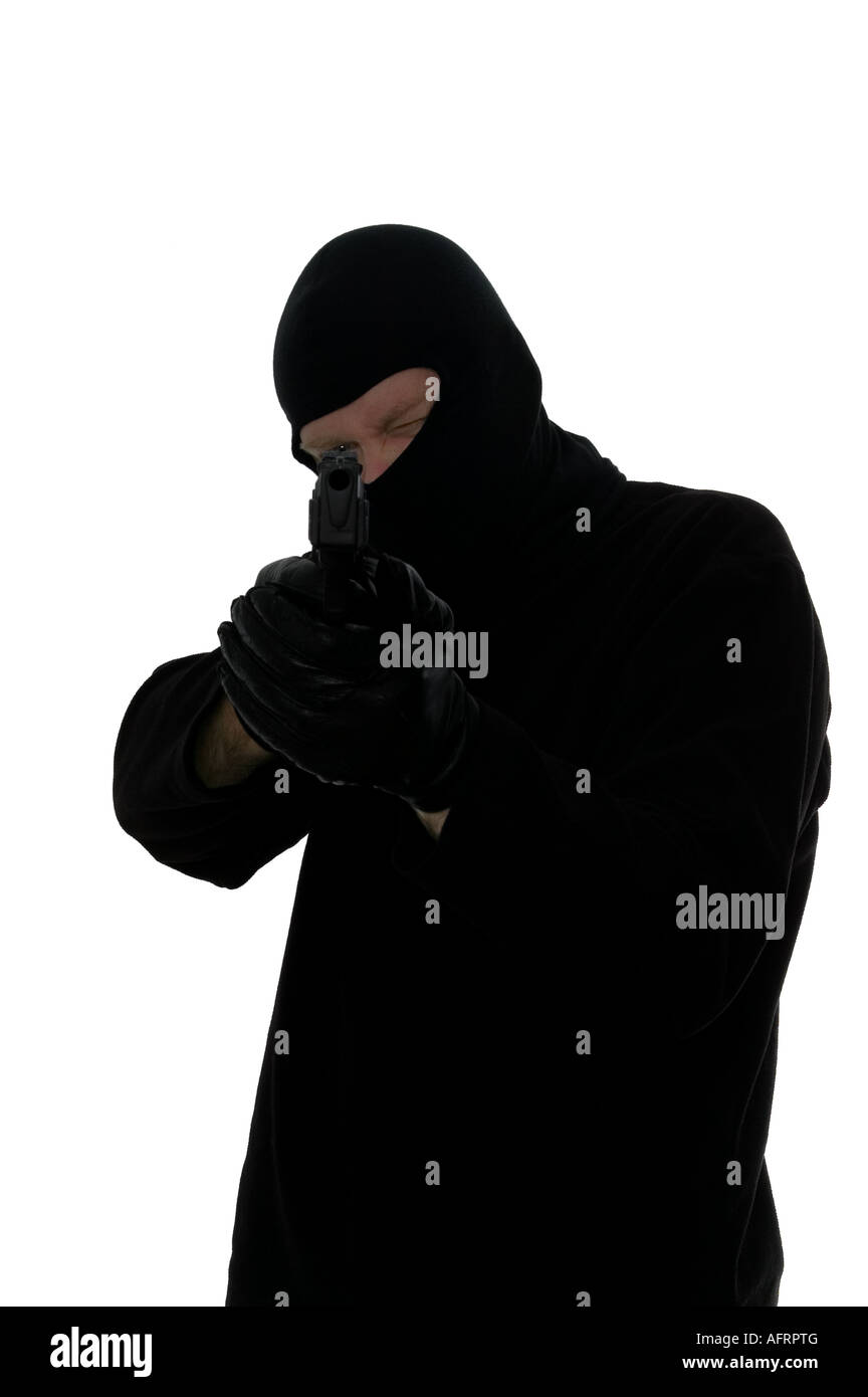 Terrorist all in black taking aim with a handgun Stock Photo