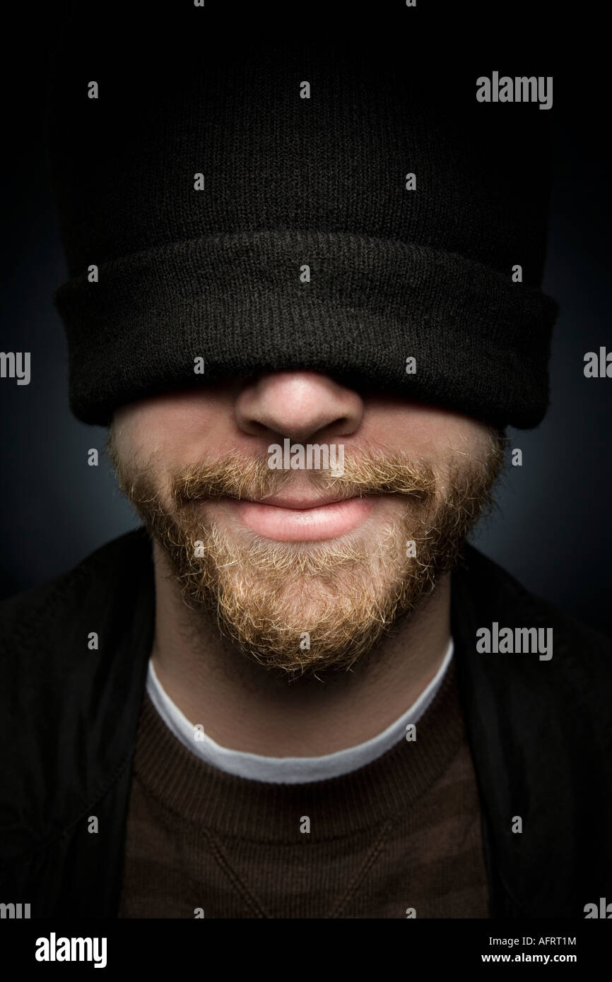 Young man with a stocking cap pulled over his eyes Stock Photo